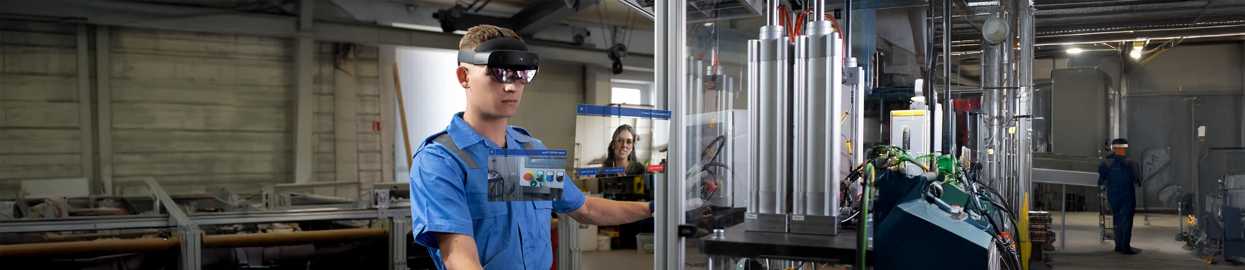 Man wearing an AR headset in a factory with a colleague visible on a video call screen.